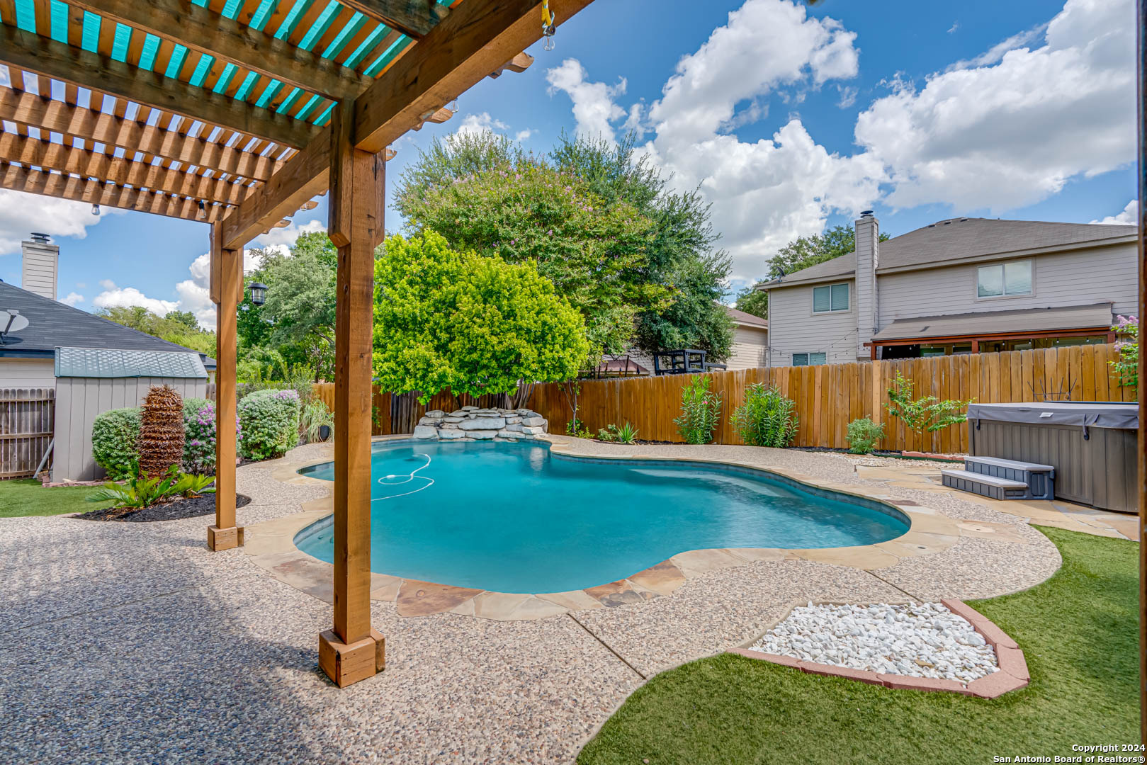 a view of a backyard with swimming pool