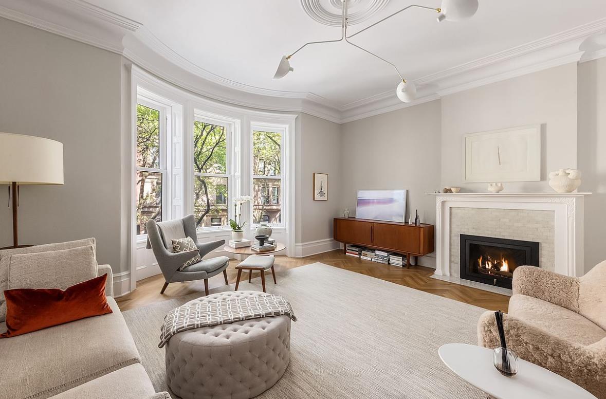 a living room with furniture fireplace and window