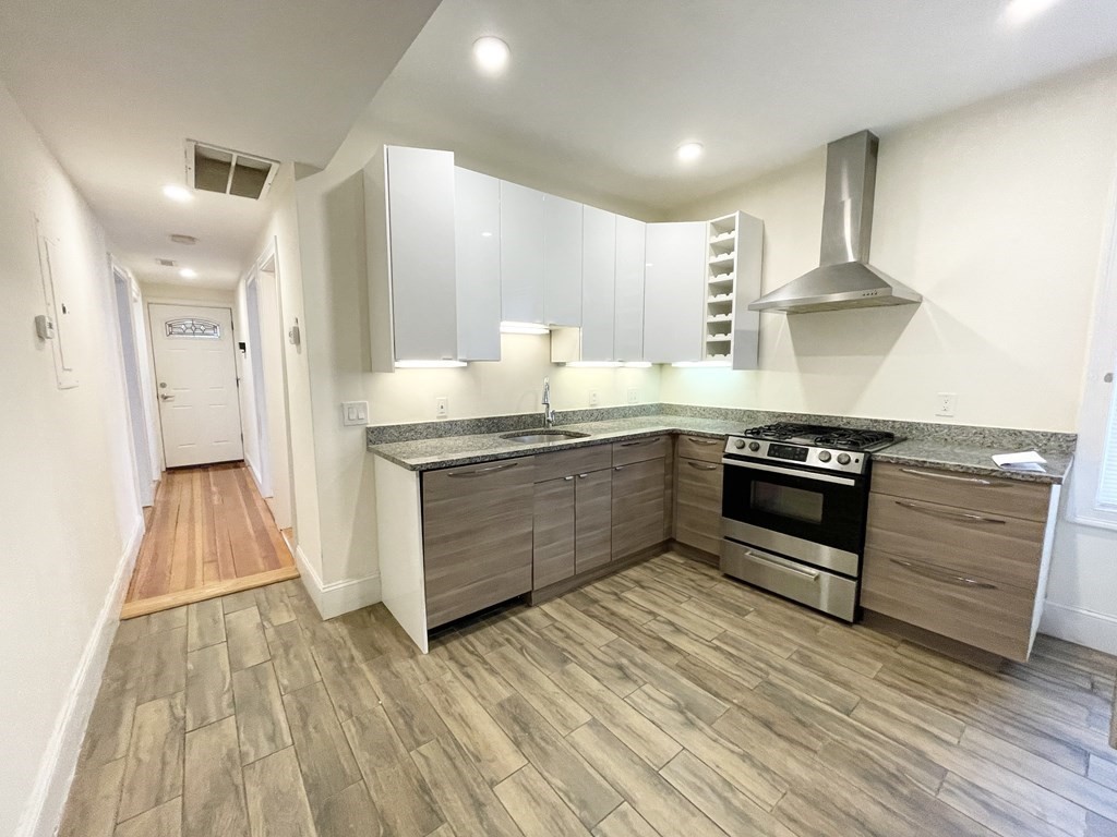 a kitchen with stainless steel appliances granite countertop a stove a sink and a refrigerator