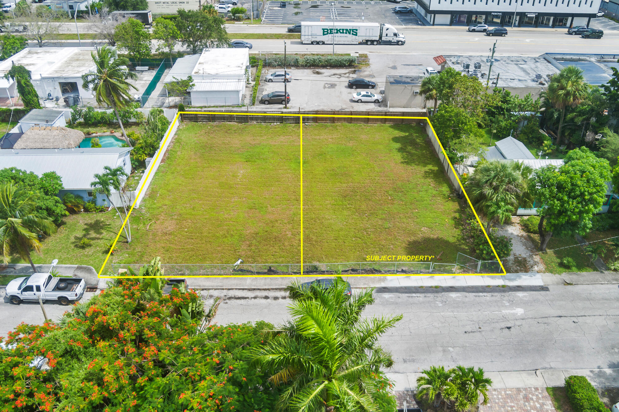 a view of a swimming pool with a lawn chairs and plants