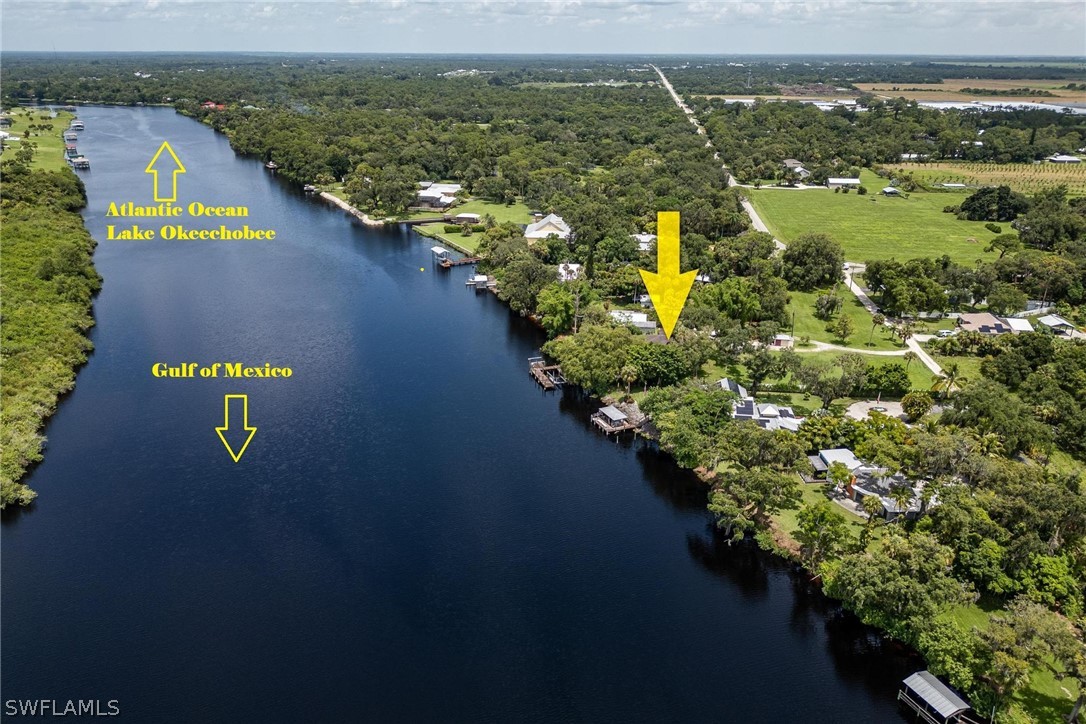 an aerial view of lake and residential houses with outdoor space