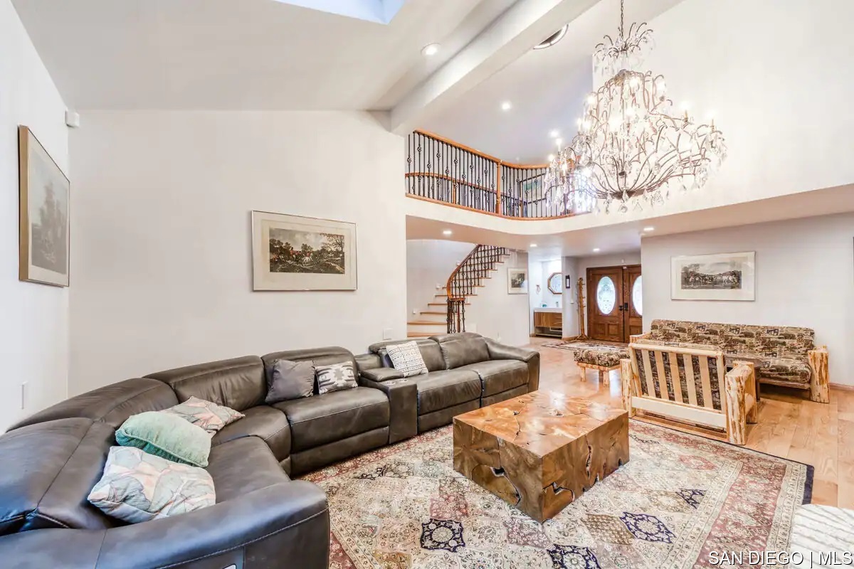 a living room with furniture and a chandelier