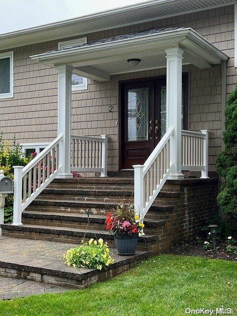 a view of a house with wooden deck and a porch