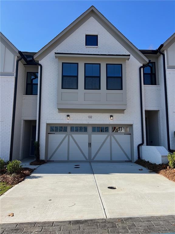 a front view of a house with garage