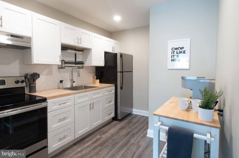 a kitchen with a sink stainless steel appliances and cabinets