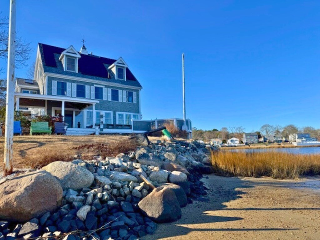 a front view of a house with lake view and mountain view in back