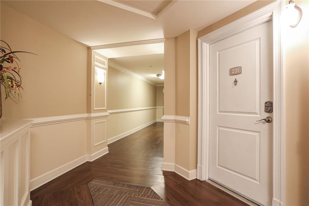 a view of empty room with wooden floor