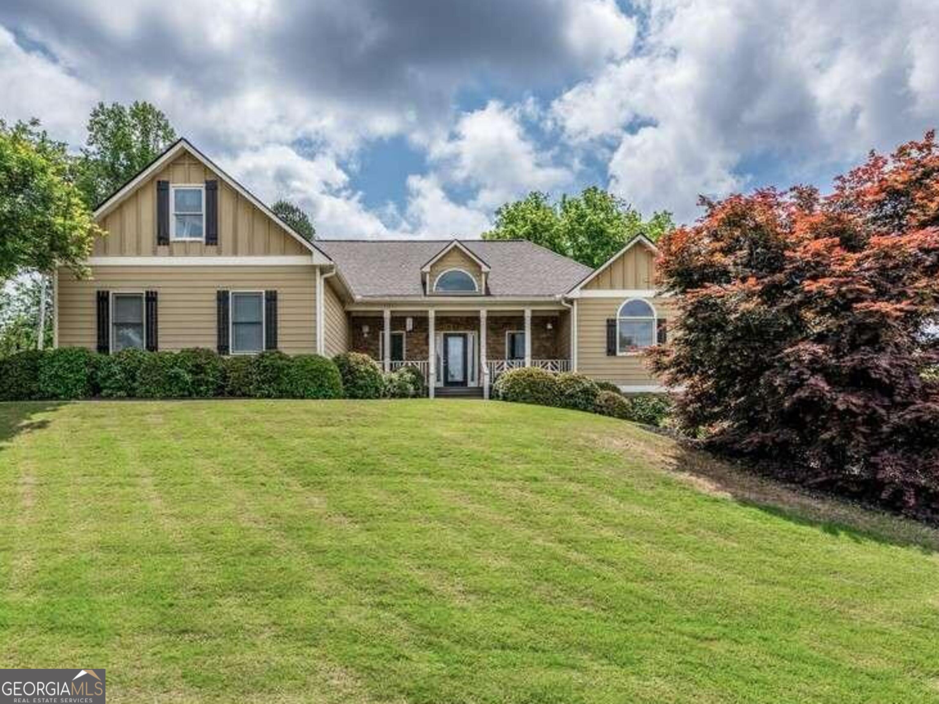 a front view of a house with a garden