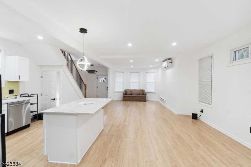 a large kitchen with a large counter top appliances and cabinets