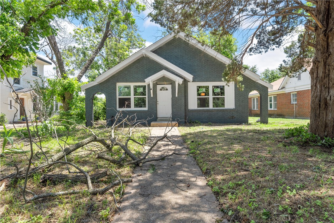 a house that has a tree in front of the house