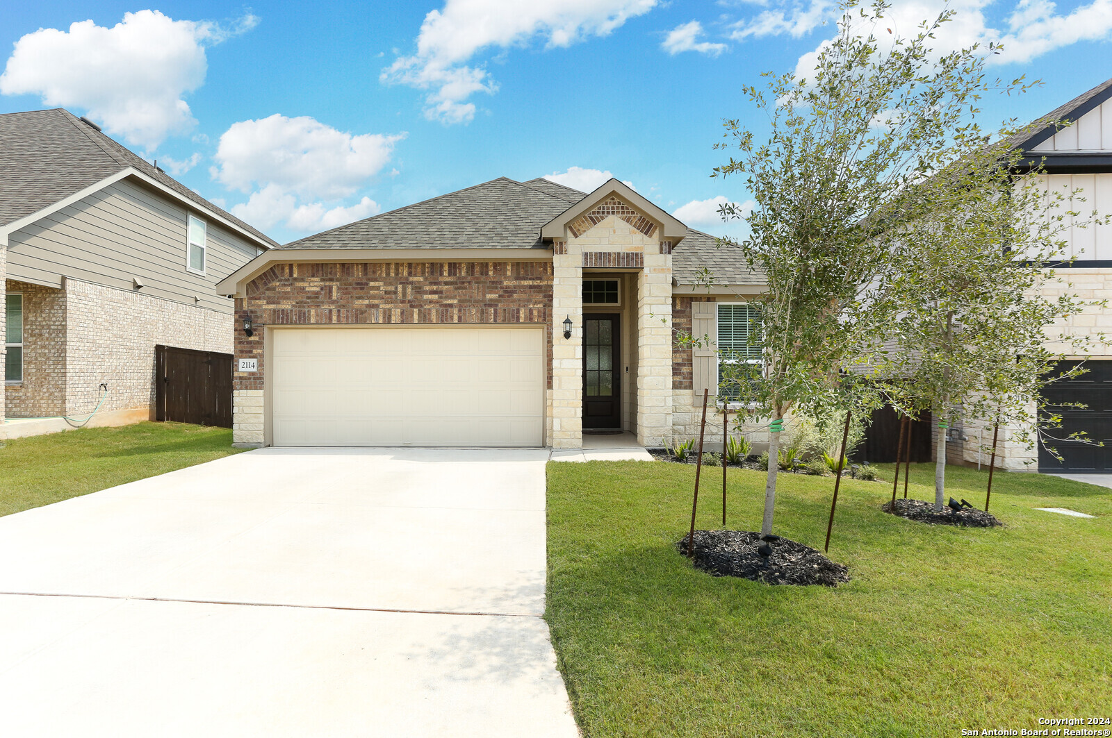 a front view of a house with a yard