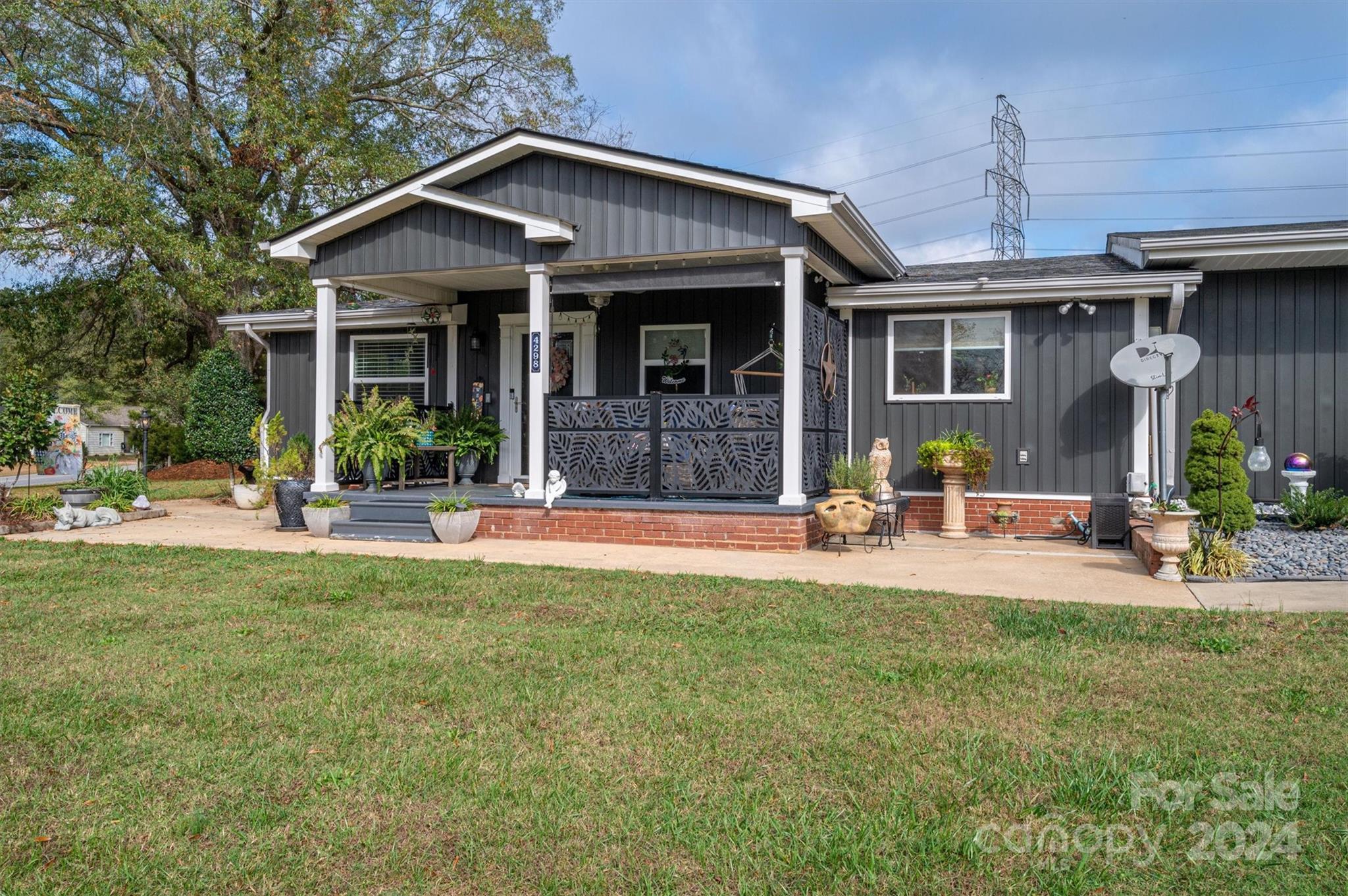 a front view of a house with swimming pool and porch