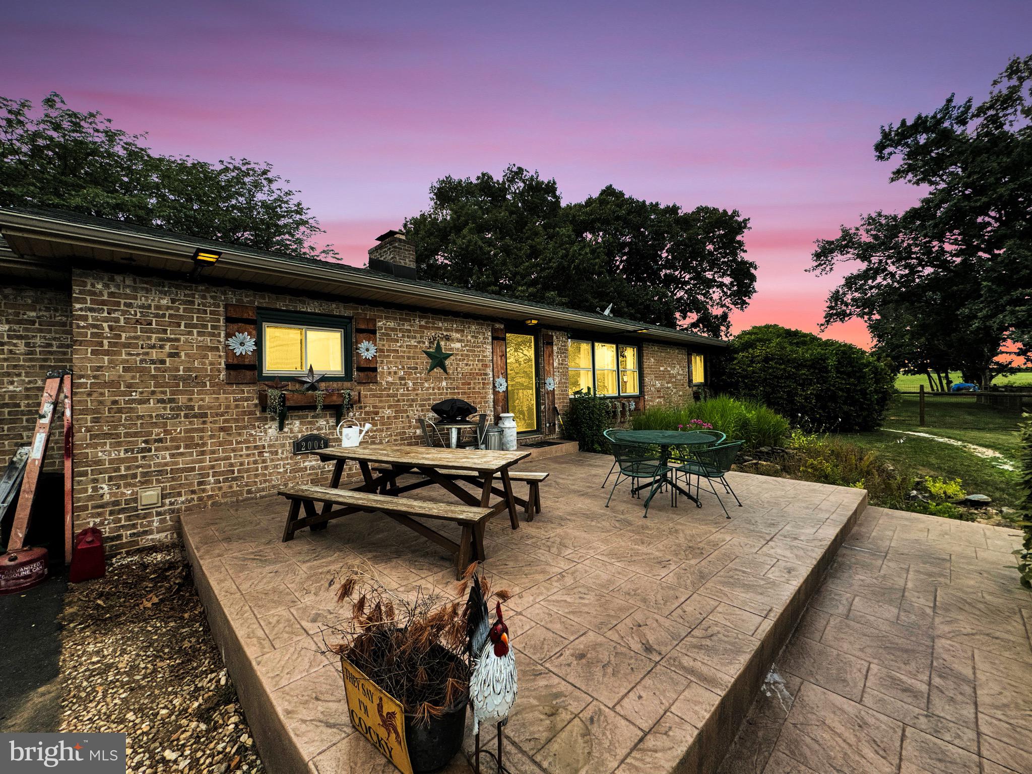 a backyard of a house with outdoor seating