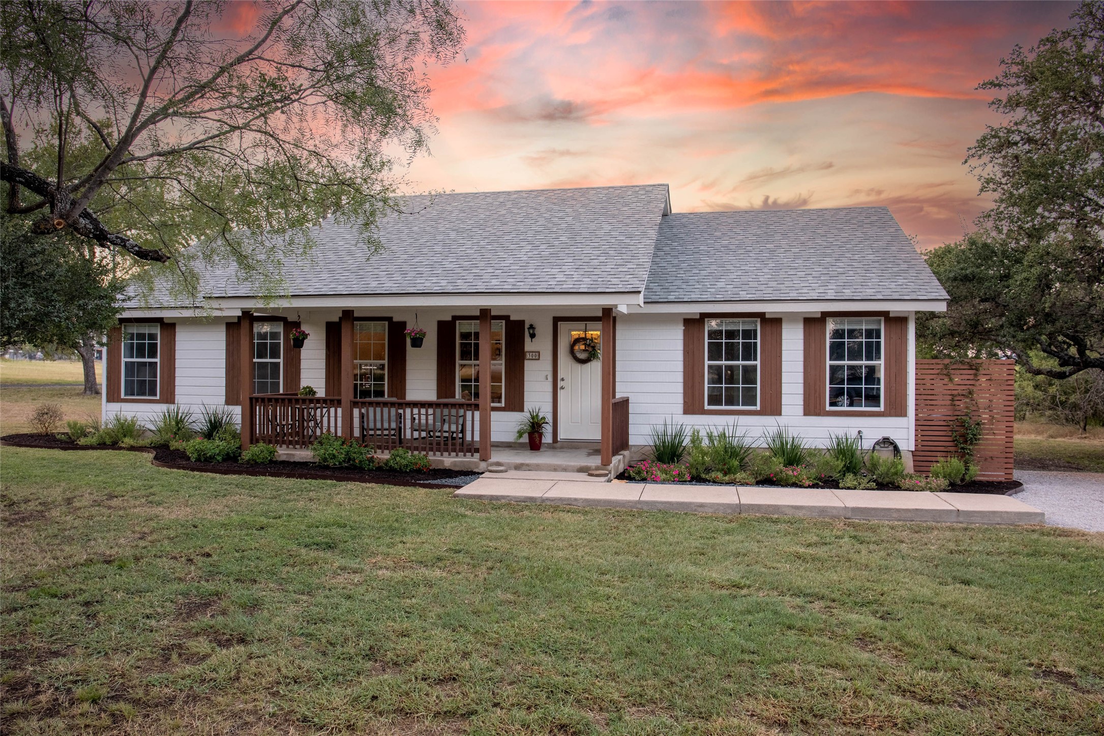 a front view of a house with garden