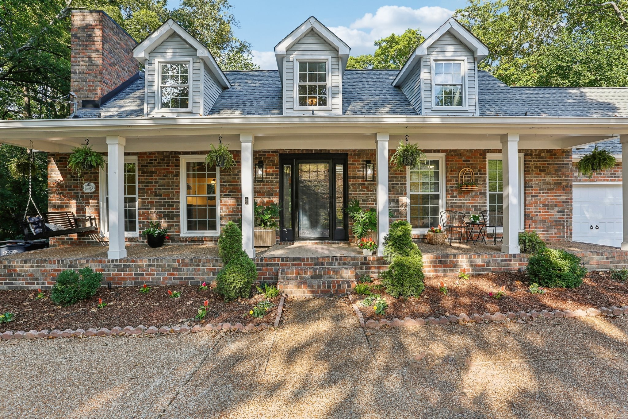 front view of a brick house with a large windows