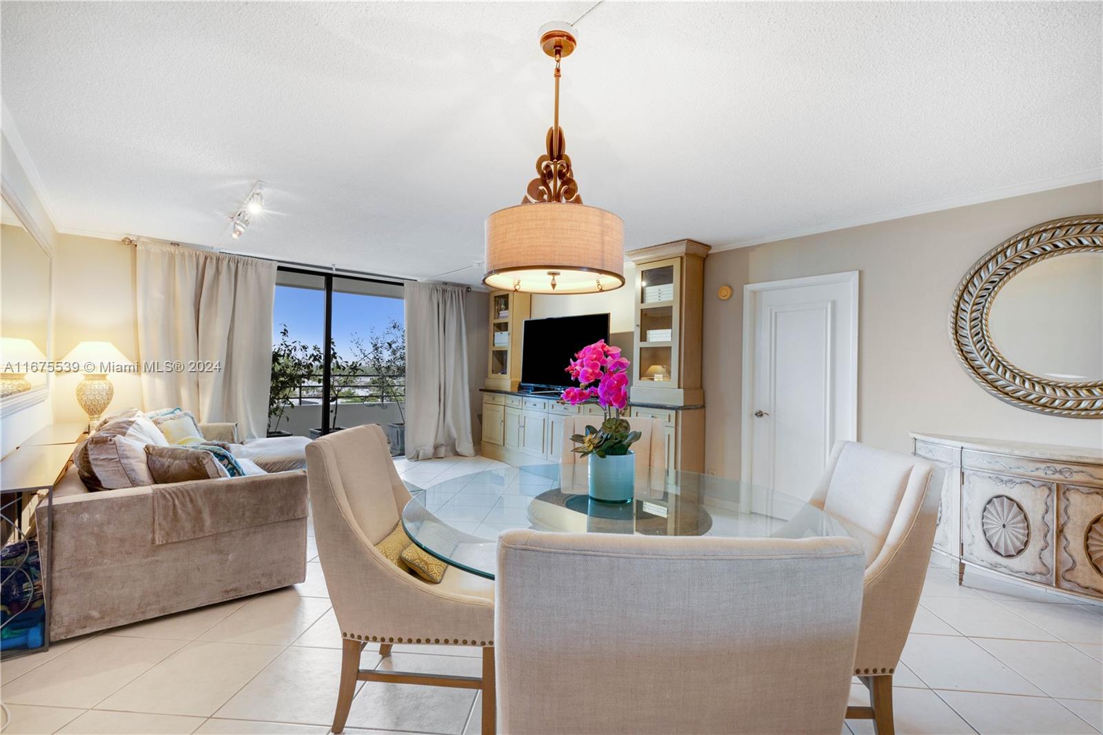 a living room with furniture and a chandelier