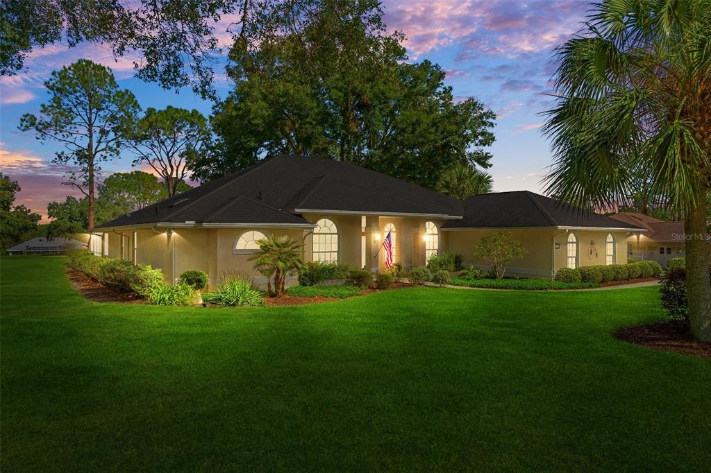 a view of an house with backyard space and garden