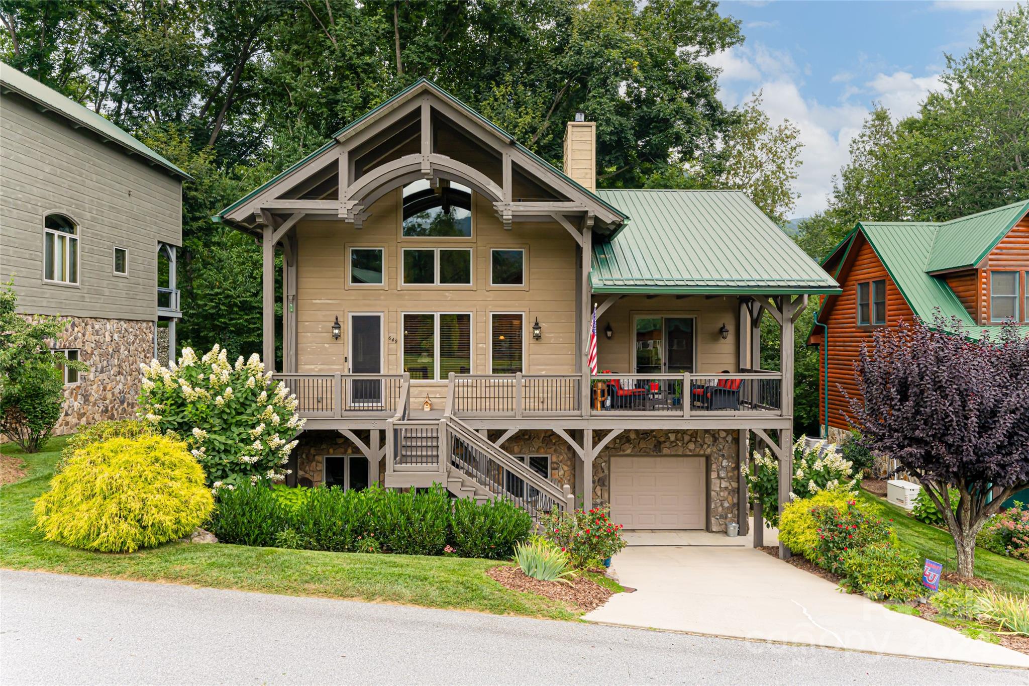 a front view of a house with a yard and potted plants