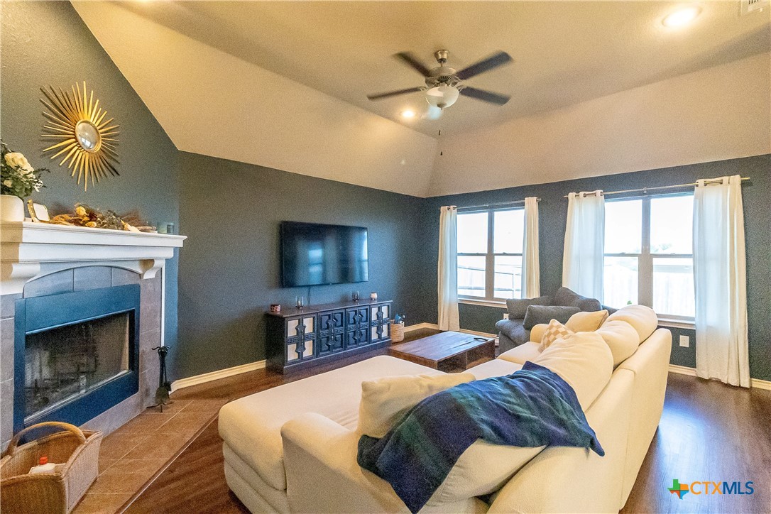 a spacious bedroom with a bed and wooden floor