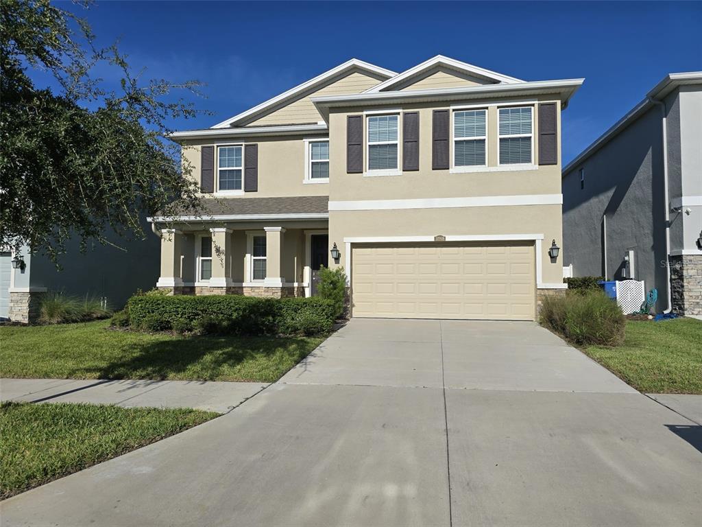 a front view of a house with a yard and garage