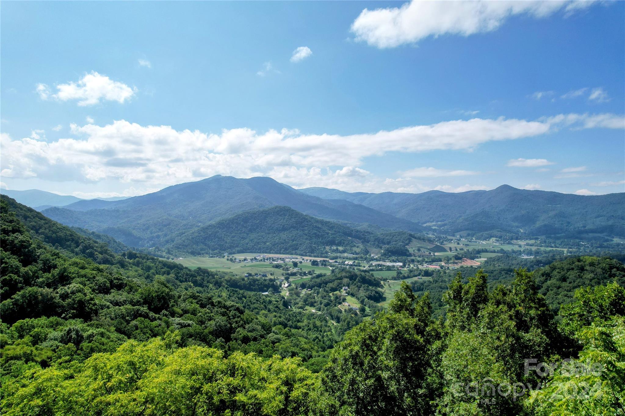 a view of a house with a mountain in the background