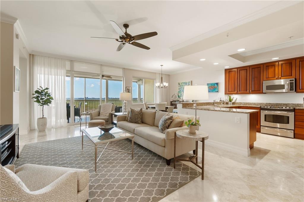 a living room with kitchen island furniture and a kitchen view