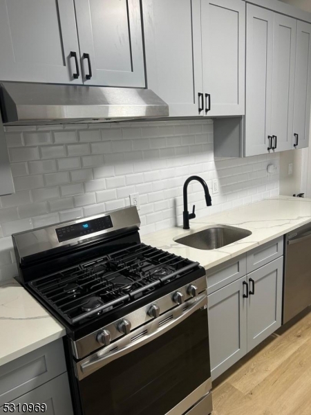 a close view of a stove a sink and dishwasher