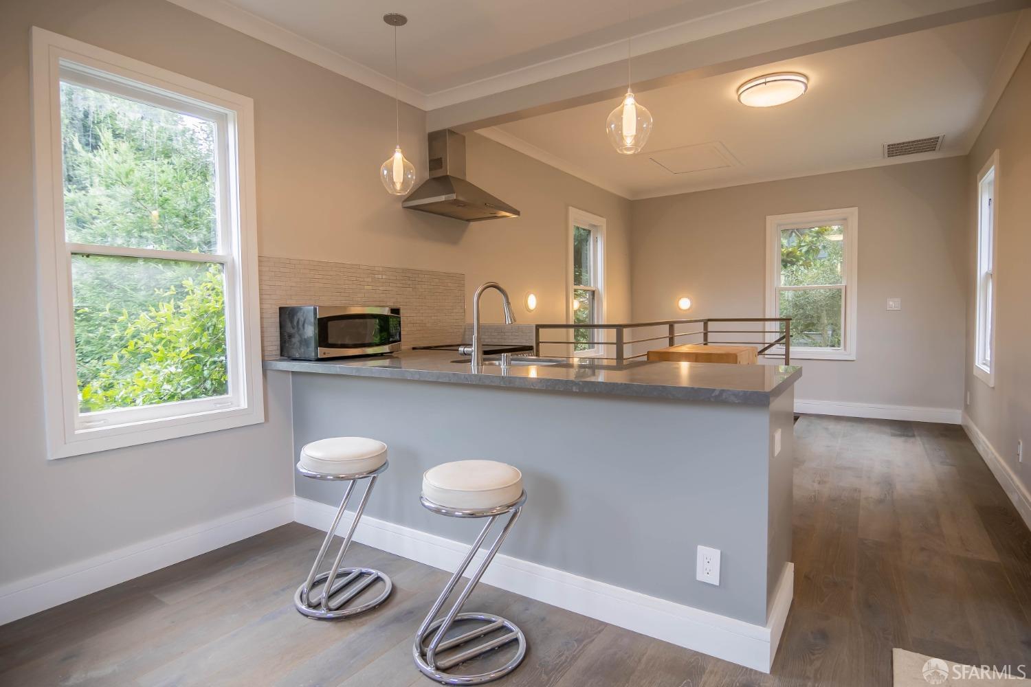 a kitchen with a table chairs and a window