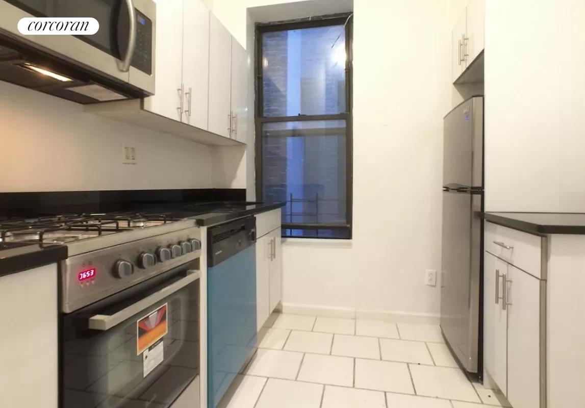 a kitchen with stainless steel appliances granite countertop a stove and a refrigerator