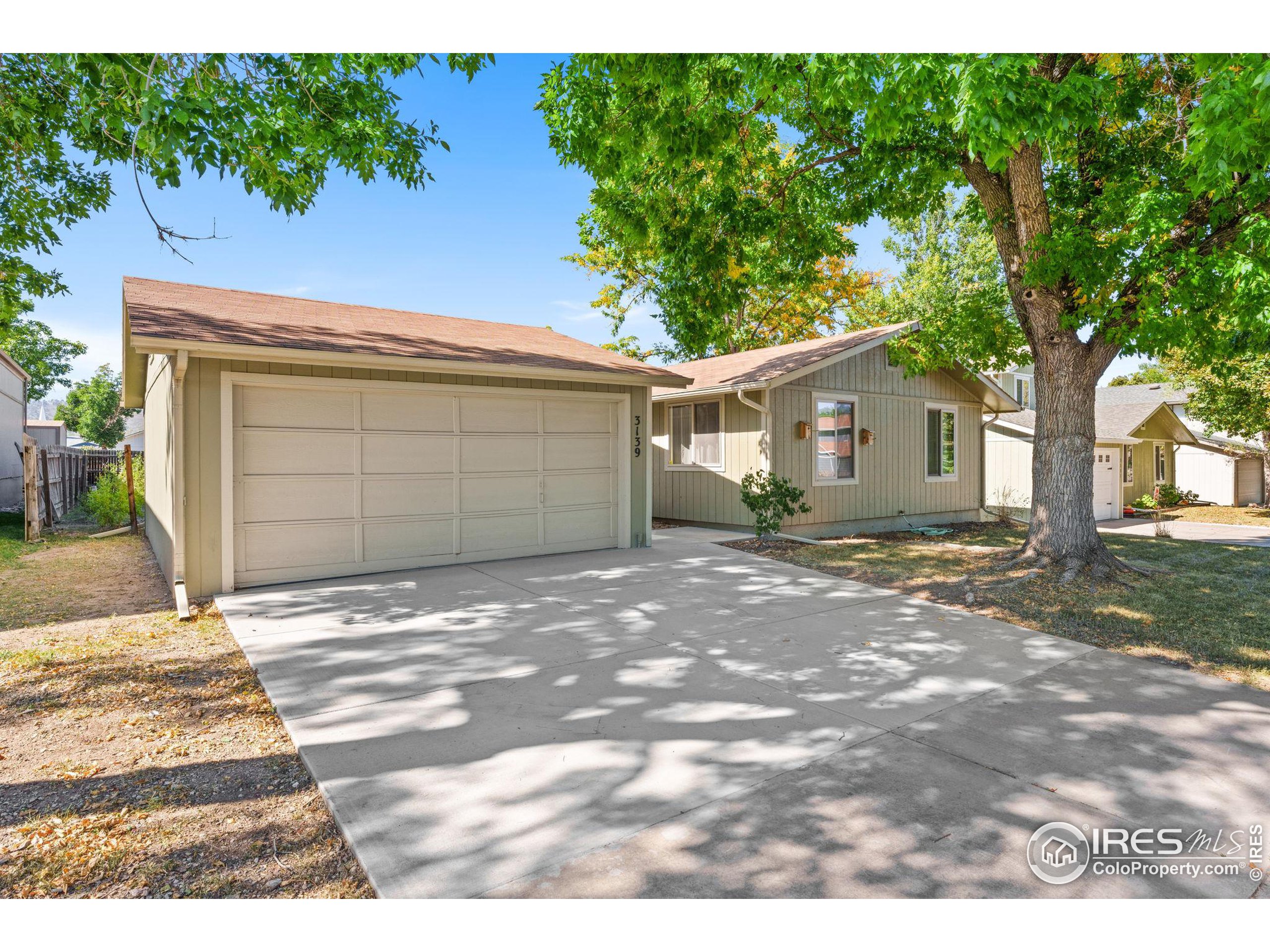 a view of backyard of house with garage