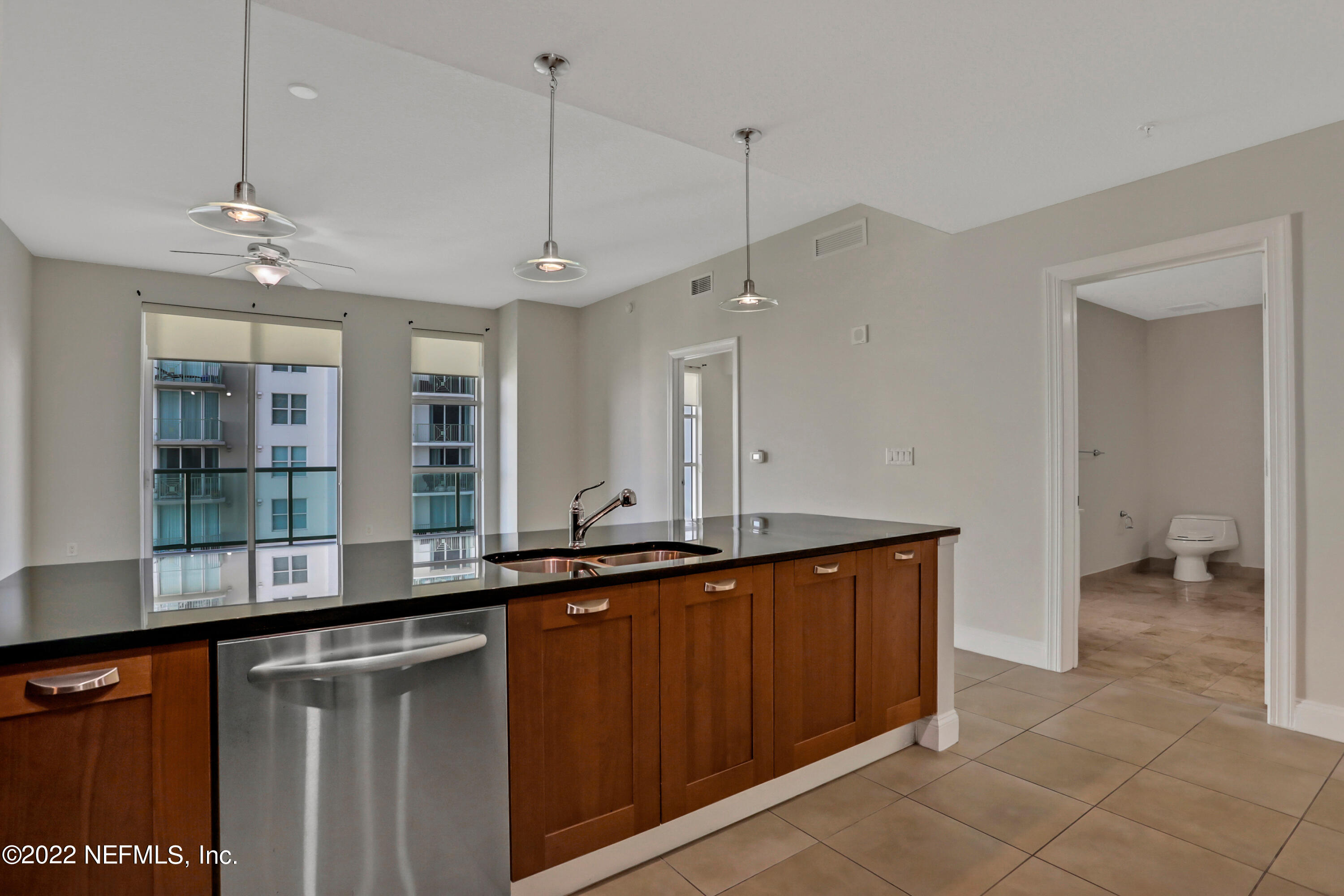 a kitchen with a sink and chandelier