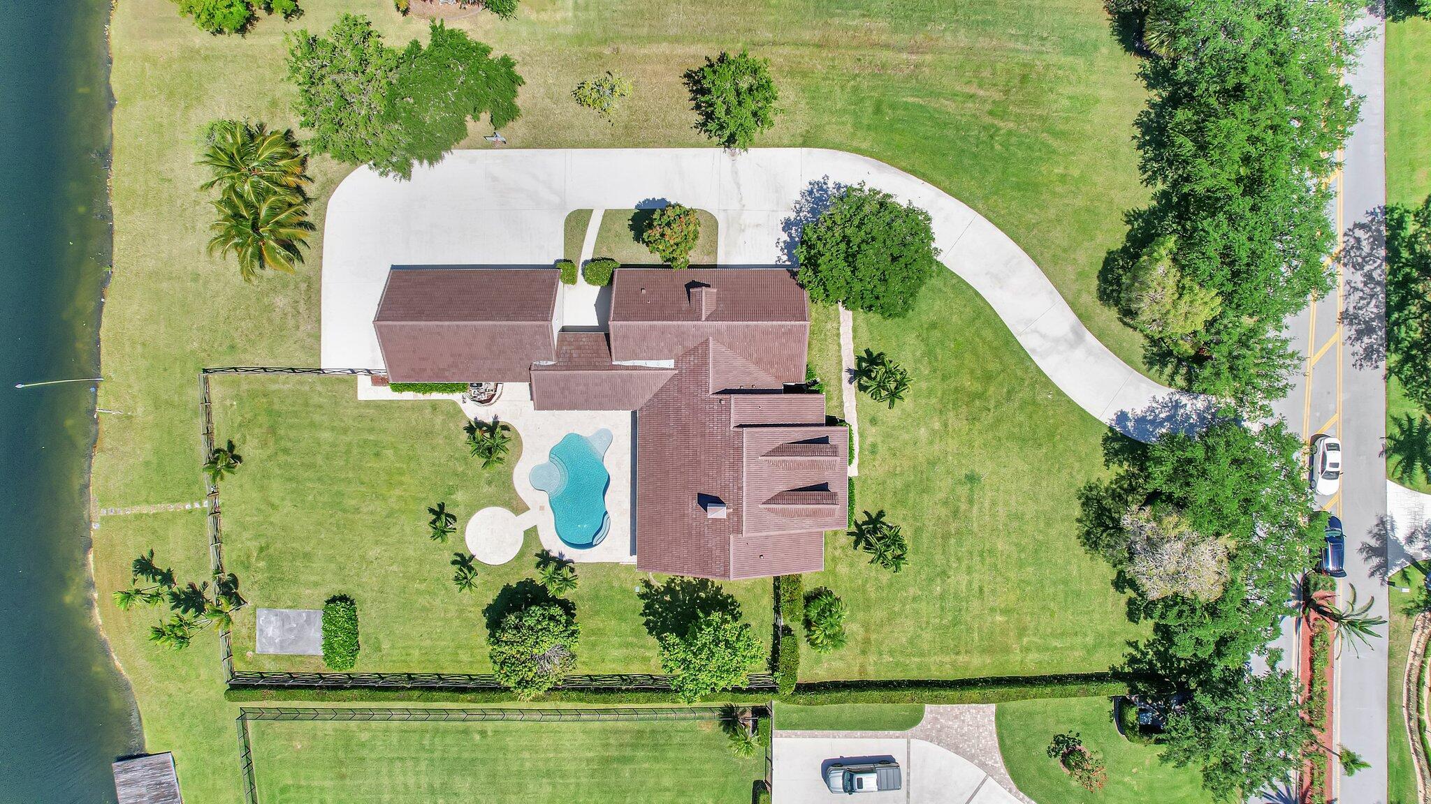 an aerial view of residential house with outdoor space and swimming pool