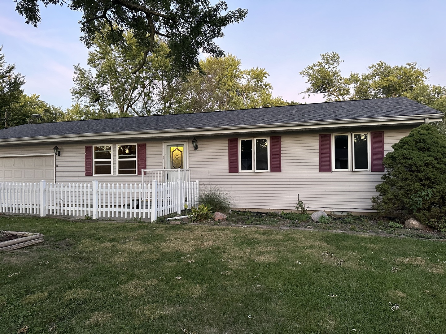 a front view of a house with a garden