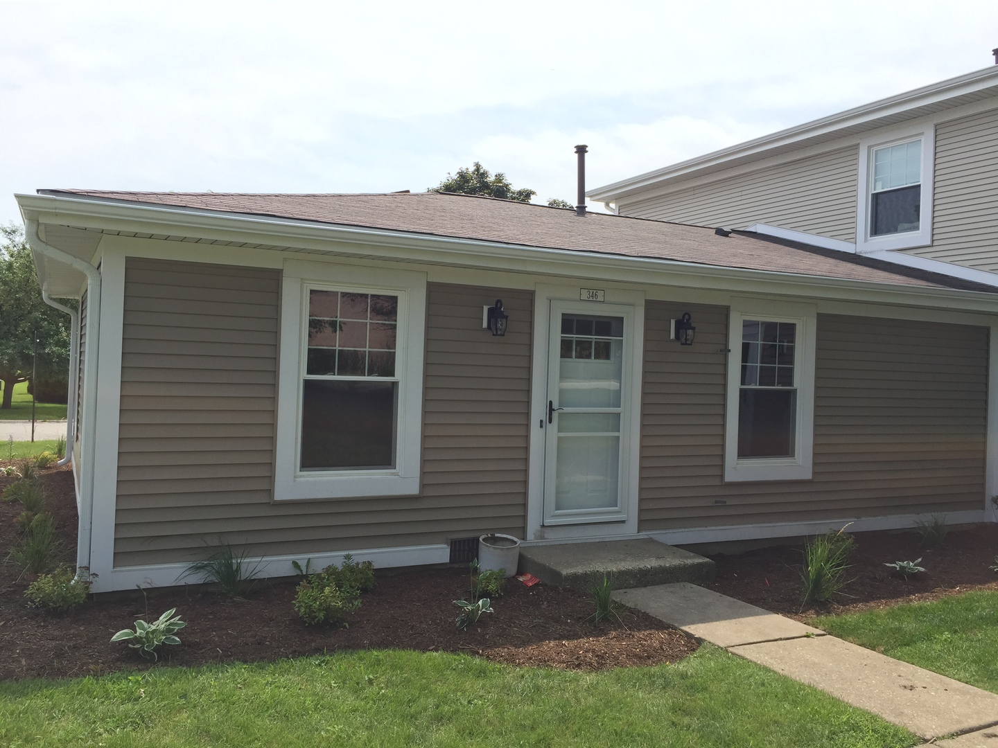 a front view of a house with a yard