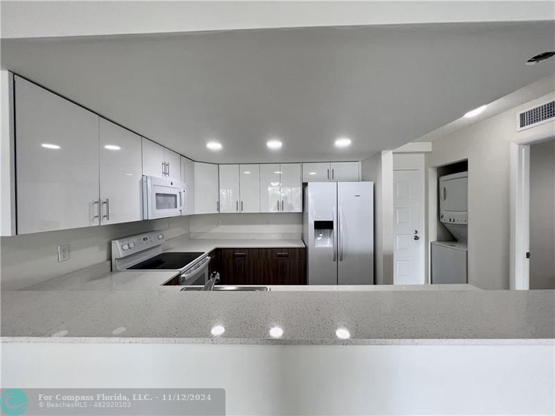 a view of a large room with kitchen island