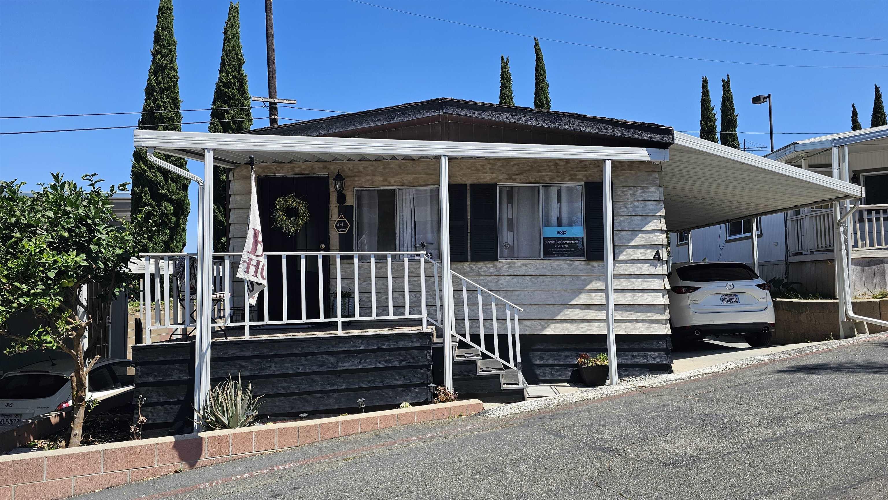 a front view of a house with a parking space