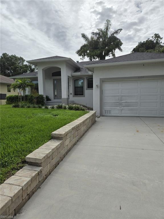 a view of a house with a yard and garage