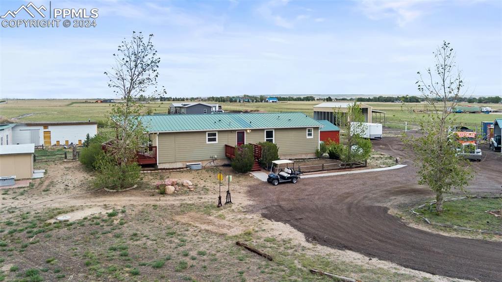 a view of a house with yard and lake view