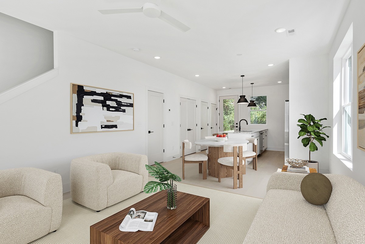 a living room with furniture and a potted plant