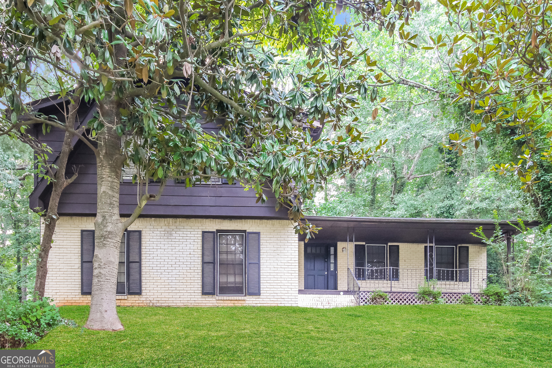 a front view of a house with a garden and yard