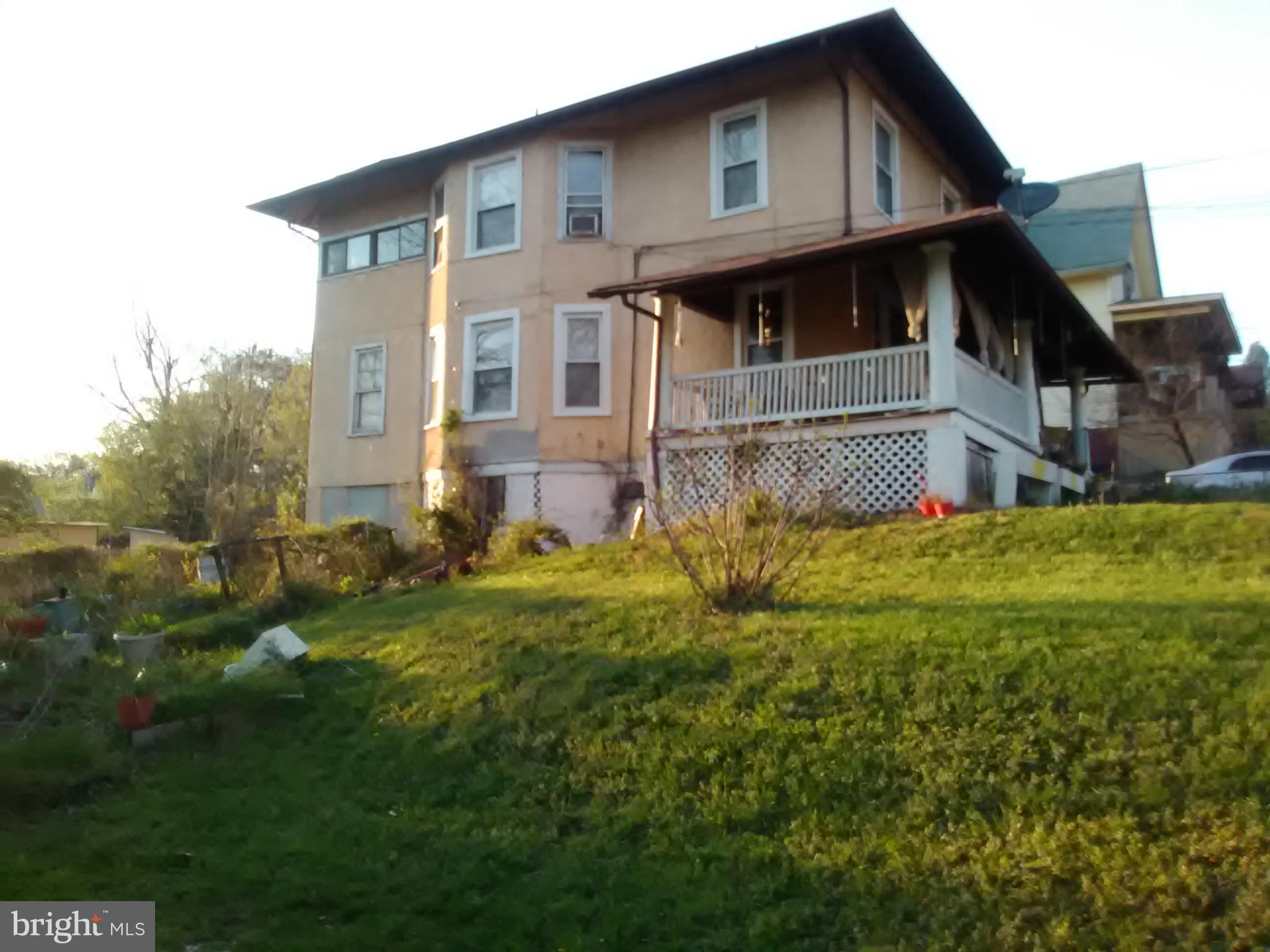 a front view of house with yard and trees