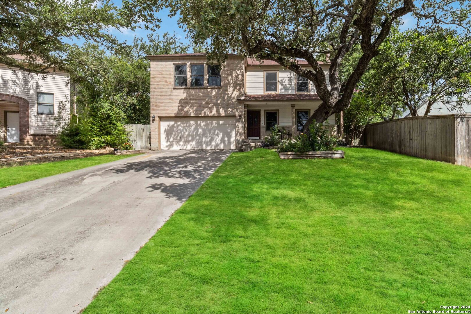 a front view of a house with yard porch and garden