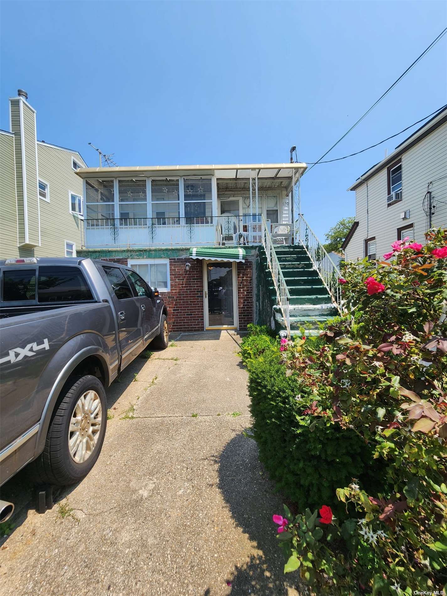 a front view of a house with a garden