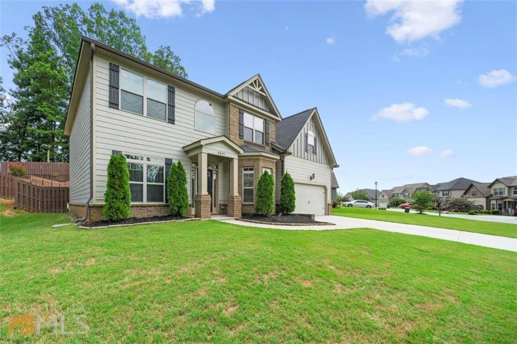 a view of a house with a yard and sitting area