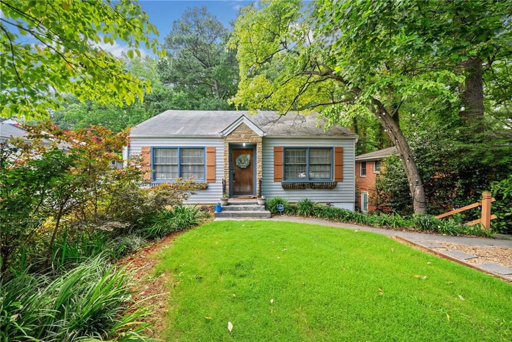 a front view of a house with yard patio and green space