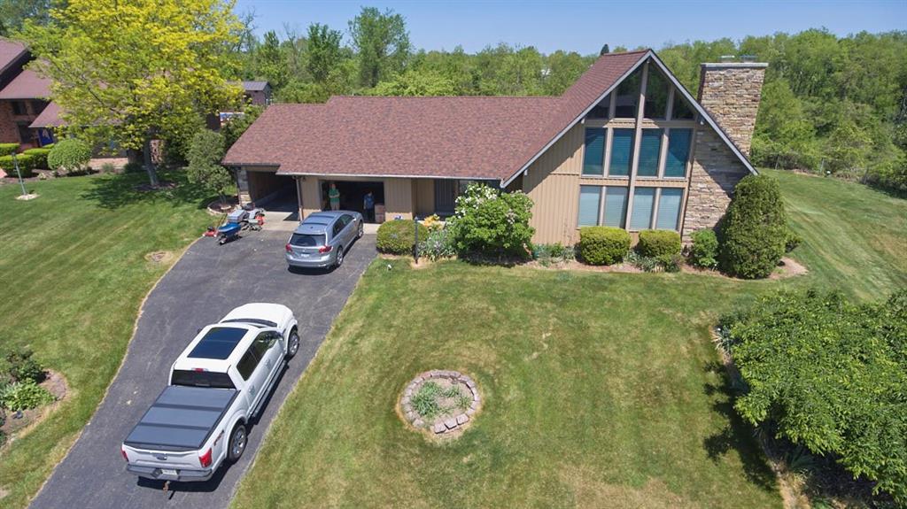 a aerial view of a house with swimming pool and porch