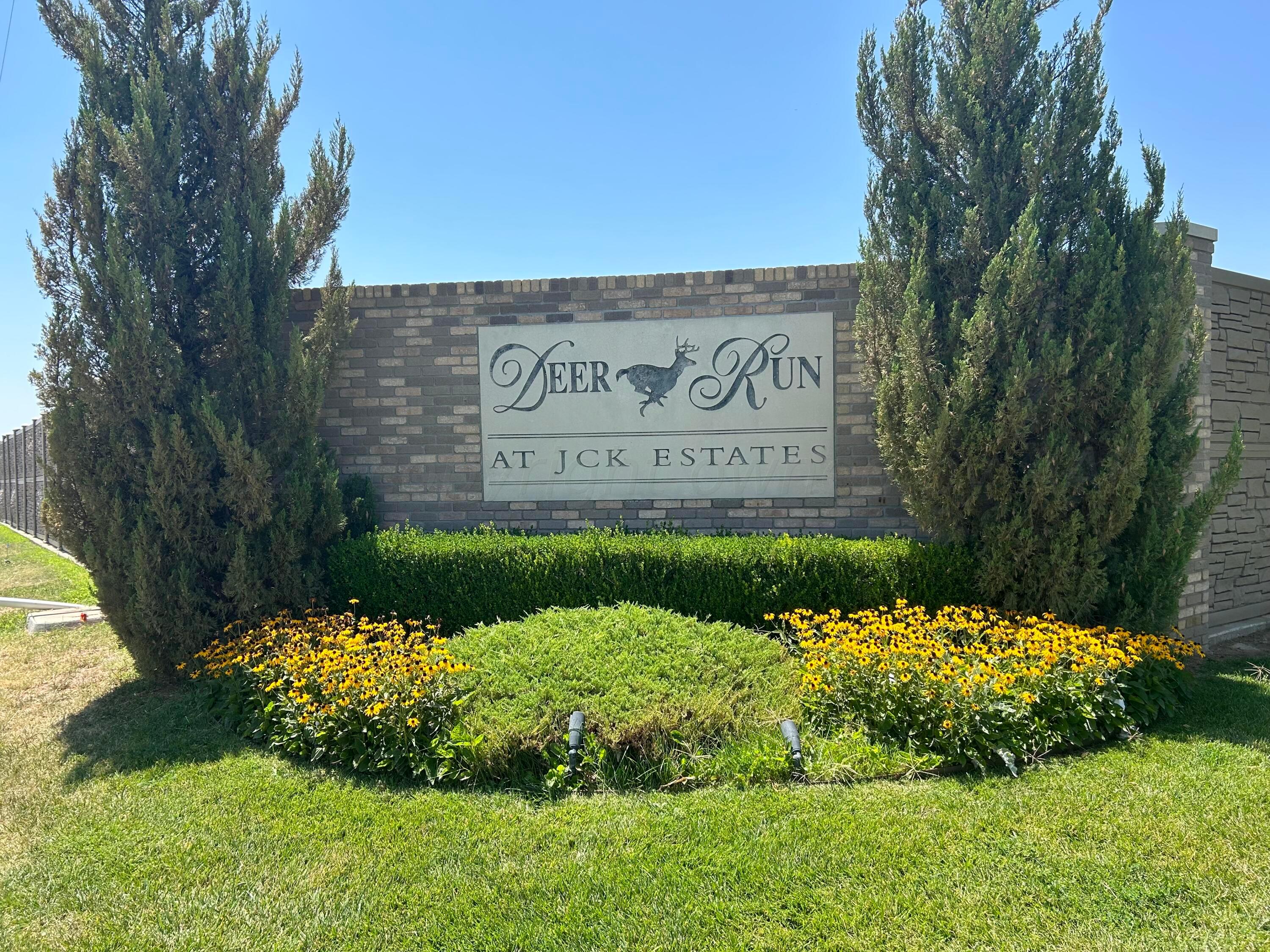 a view of a sign board and yard