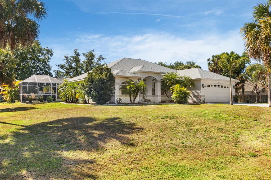 a front view of house with yard and trees