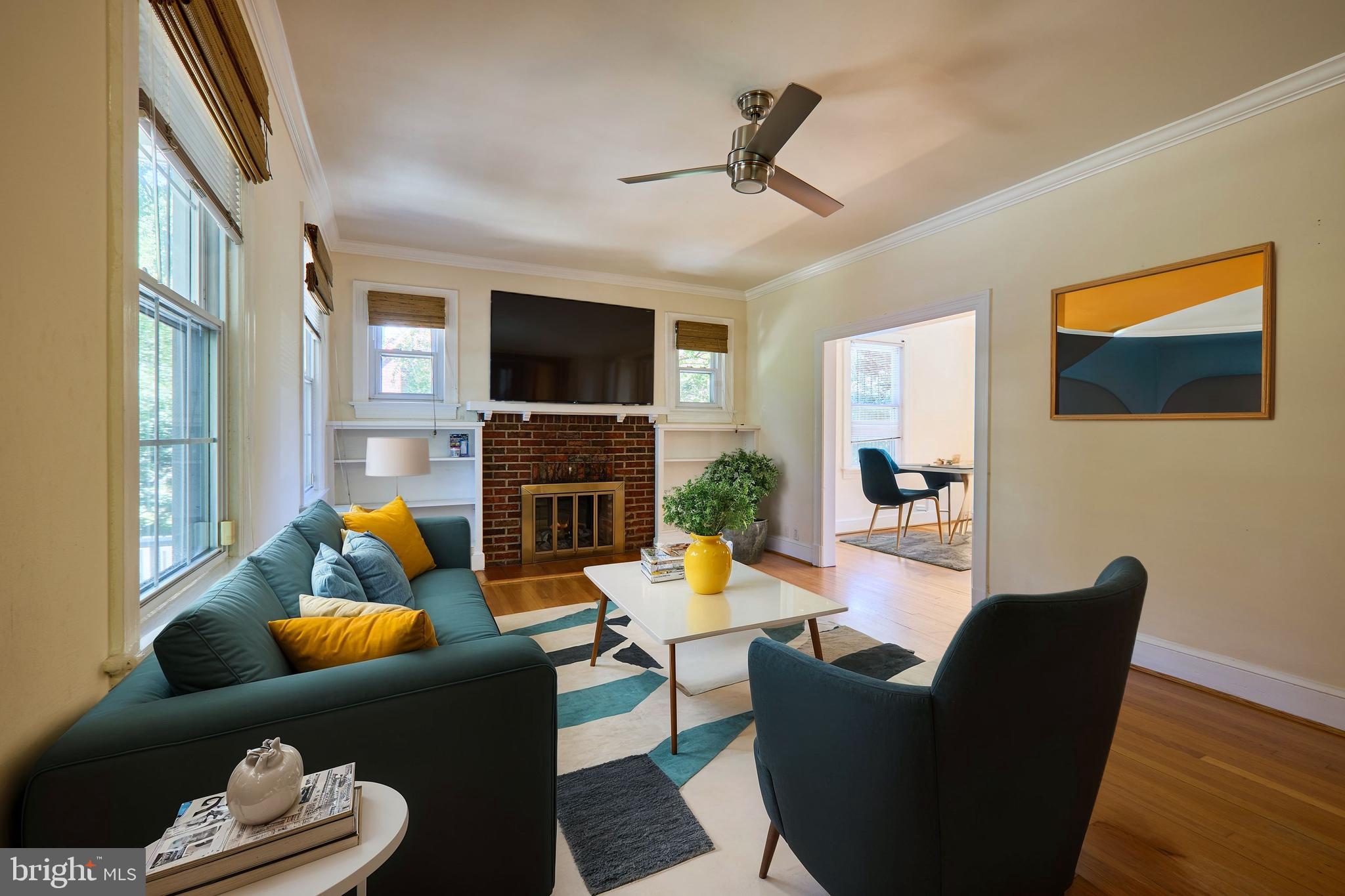 a living room with furniture a flat screen tv and a fireplace