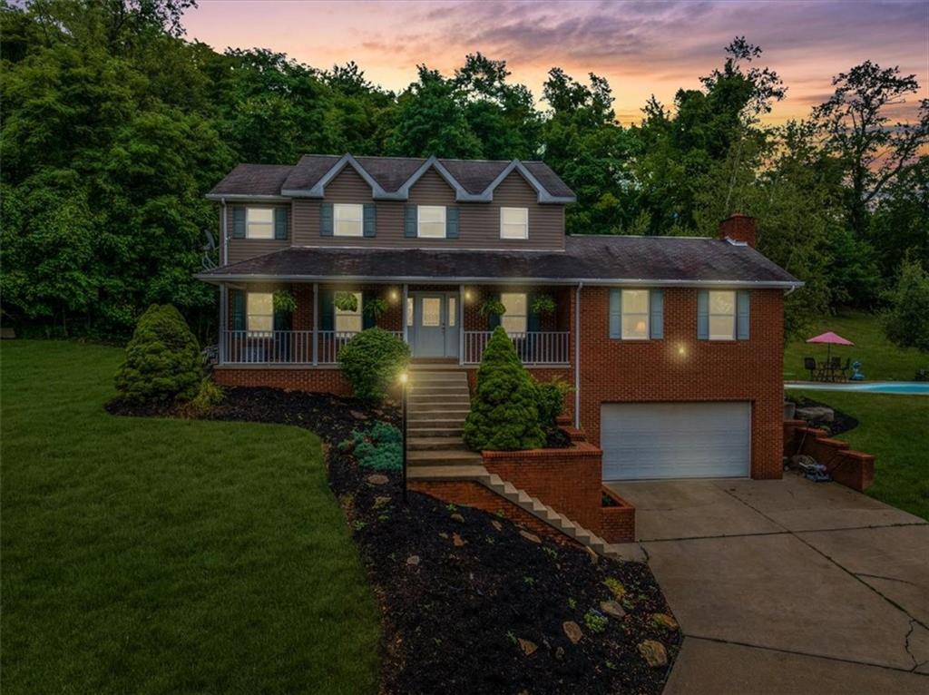 a front view of a house with a garden